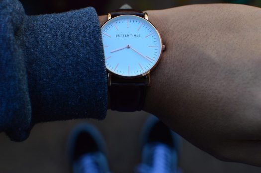 a close up of a watch face on someone's wrist. The watch face says "better times."